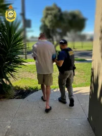 Photos of a Border Force agent escorting a man in handcuffs