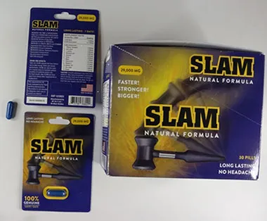 Packaging and a blue capsule of a product labelled "SLAM Natural Formula", displayed beside a box and blister-pack packaging.