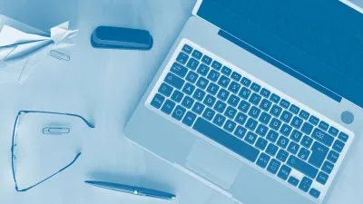 laptop with glasses and stationery with blue tint