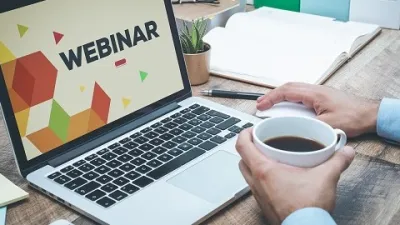 man with laptop watching webinar