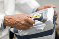 Photo of a medical practitioner holding an ultrasound device